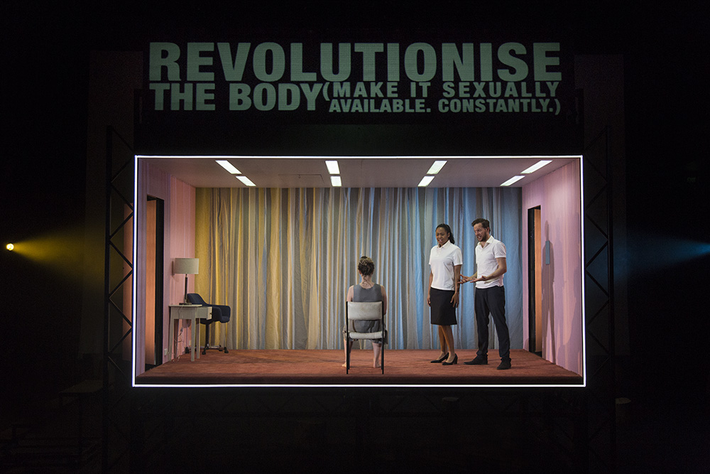 Production still for "Revolt. She Said. Revolt Again." L-R: Sophie Ross, Elizabeth Esguerra, Gareth Reeves. Photographer: Pia Johnson